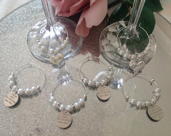 May include: Set of six silver-toned glass charms with white pearl beads. The charms feature the words "Bride", "Groom", and "Thank you for sharing our day".
