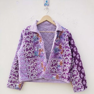 May include: A white ceramic mug with a black handle and the text "But First, Coffee" in a bold, black font. The mug is set against a neutral background, highlighting its simple design.