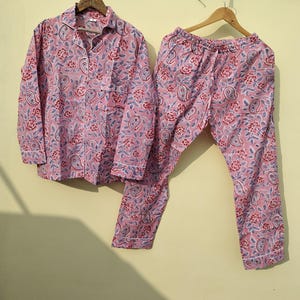 May include: A pink and blue paisley patterned pajama set with long sleeves and pants.