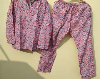 May include: A pink and blue paisley patterned pajama set with long sleeves and pants.