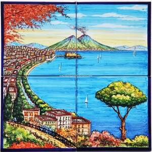 May include: A colorful ceramic tile mural depicting a cityscape with a volcano in the background. The city is on a coastline with a blue sea and boats. The mural is divided into four tiles.