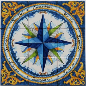 May include: A blue and white compass rose tile with a yellow rope border and gold accents. The tile features the Italian words for the cardinal directions: Nord, Sud, Est, Ovest, and the names of the winds: Tramontana, Grecale, Levante, Scirocco, Mezzogiorno, Libeccio, Ponente, Maestrale.