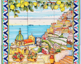 May include: A colorful ceramic tile mural depicting a view of Positano, Italy. The mural features a lemon tree, a church with a dome, colorful buildings, and a blue sea with boats. The text "Positano" is visible at the bottom of the mural.