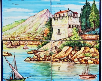 May include: A colorful ceramic tile mural depicting a coastal scene with a white building, a mountain, and sailboats in the water. The tile is labeled "Vietri" in the bottom right corner.