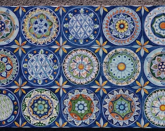 May include: A set of 18 blue and white ceramic tiles with colorful circular designs. Each tile features a different pattern, including floral motifs, geometric shapes, and abstract designs.