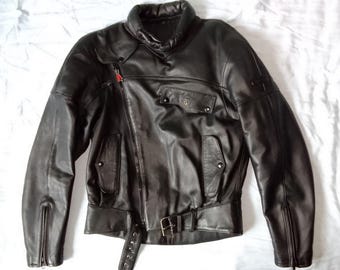 May include: A black leather motorcycle jacket with a zippered front and a belt at the waist.
