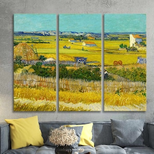 May include: A triptych canvas print of a landscape painting. The artwork depicts a rural scene with a field of wheat, a haystack, and a farmhouse under a blue sky. The painting is in the style of Van Gogh, with visible brushstrokes and vibrant colors.