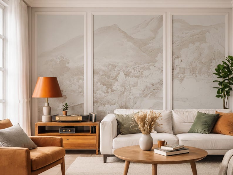 May include: A living room interior with a white sofa, wooden furniture, and a landscape mural. The room includes a wooden coffee table, an orange lamp, and a leather armchair. The decor is complemented by green and orange cushions.