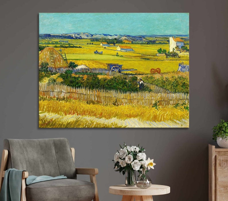 May include: A framed canvas print of a landscape painting. The artwork depicts a rural scene with fields of wheat, a farmhouse, and a blue sky. The painting has a textured appearance with visible brushstrokes, and the color palette is dominated by yellows, greens, and blues.