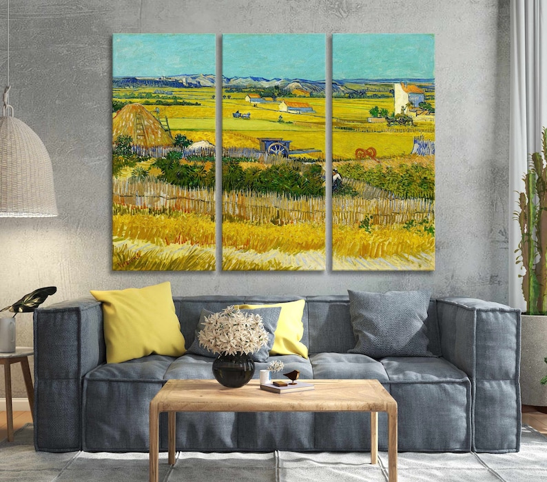 May include: A triptych canvas print of a landscape painting. The artwork depicts a rural scene with a field of wheat, a haystack, and a farmhouse under a blue sky. The painting is in the style of Van Gogh, with visible brushstrokes and vibrant colors.