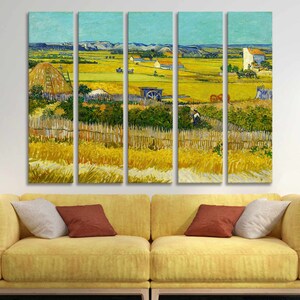May include: A five-panel canvas print of a landscape painting. The artwork depicts a rural scene with a field of yellow wheat, a blue sky, and a few buildings. The painting is in the style of Van Gogh, with visible brushstrokes and vibrant colors.
