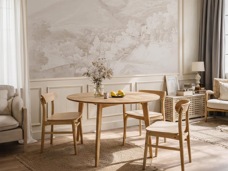 May include: A light wood dining table with four matching chairs. The round table is set on a woven rug, with a vase of dried flowers and lemons as a centrepiece. The room has a neutral colour palette.