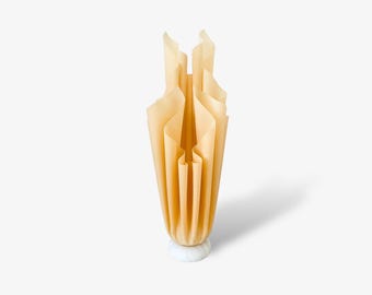 May include: A beige ceramic lamp with a pleated shade and a white marble base.