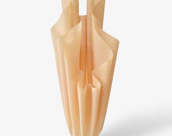 May include: A beige lamp with a pleated fabric shade and a white marble base.