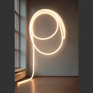 May include: A modern, minimalist light fixture. A continuous, glowing neon tube in a warm white color is mounted on a gray wall, forming a looping design. The light extends to the floor, creating a striking visual element in the room.