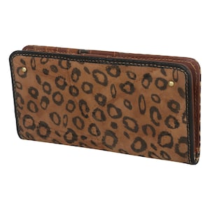 May include: A brown leather wallet with a leopard print pattern. The wallet has a bi-fold design with a black border and gold-colored rivets. The interior is a solid brown color. The wallet is closed.