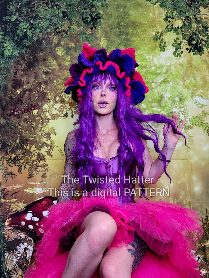 May include: A digital pattern for a crocheted hat with a purple and pink flower design. The hat is worn by a person with purple hair and a pink tutu. The text "The Twisted Hatter This is a digital PATTERN" is visible in the image.