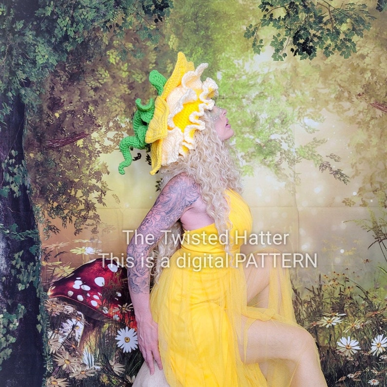 May include: A woman wearing a yellow and green crocheted flower hat with a yellow dress and a floral background. The text "The Twisted Hatter This is a digital PATTERN" is visible in the image.