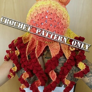 Op de afbeelding: Alleen haakpatroon. Een gehaakte octopusmuts met een rood, oranje en gele ombre kleurschema. De octopus heeft acht tentakels met een gekrulde rand.