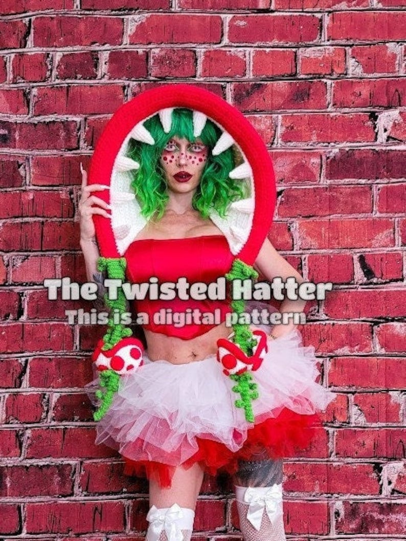 May include: A woman wearing a red and white tutu skirt and a crocheted plant monster headpiece. The headpiece is red and green with white teeth. The text "The Twisted Hatter" and "This is a digital pattern" is visible on the image.