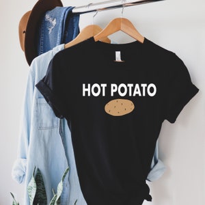 May include: Black t-shirt with white text that says "HOT POTATO" and a brown cartoon potato image.