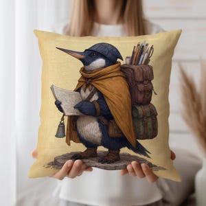 May include: Square decorative pillow featuring a whimsical illustration of a penguin adventurer. The penguin is dressed in a cape, hat, and boots, carrying a backpack and a map. The pillow has a yellow background with a vintage map design.