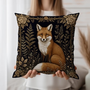 May include: Square cushion featuring a detailed illustration of a fox with orange and white fur, set against a dark blue background with floral and botanical elements. The fox is centered within a decorative border.