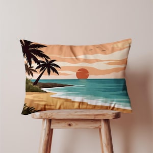May include: Rectangular pillow with a beach scene. The design features a sunset over the ocean, palm trees, and a sandy beach. The color palette includes shades of orange, blue, and brown.