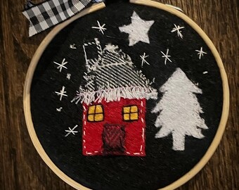 Felt and embroidered winter house with tree and star