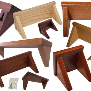 May include: Assortment of wooden shelves in various sizes and finishes, including natural wood, dark wood, and stained wood. The shelves are designed for wall mounting and feature triangular brackets.