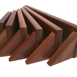 May include: Set of eight wooden corner shelves in various sizes, arranged in a fan shape. The shelves are a rich reddish-brown color and have a natural wood grain.