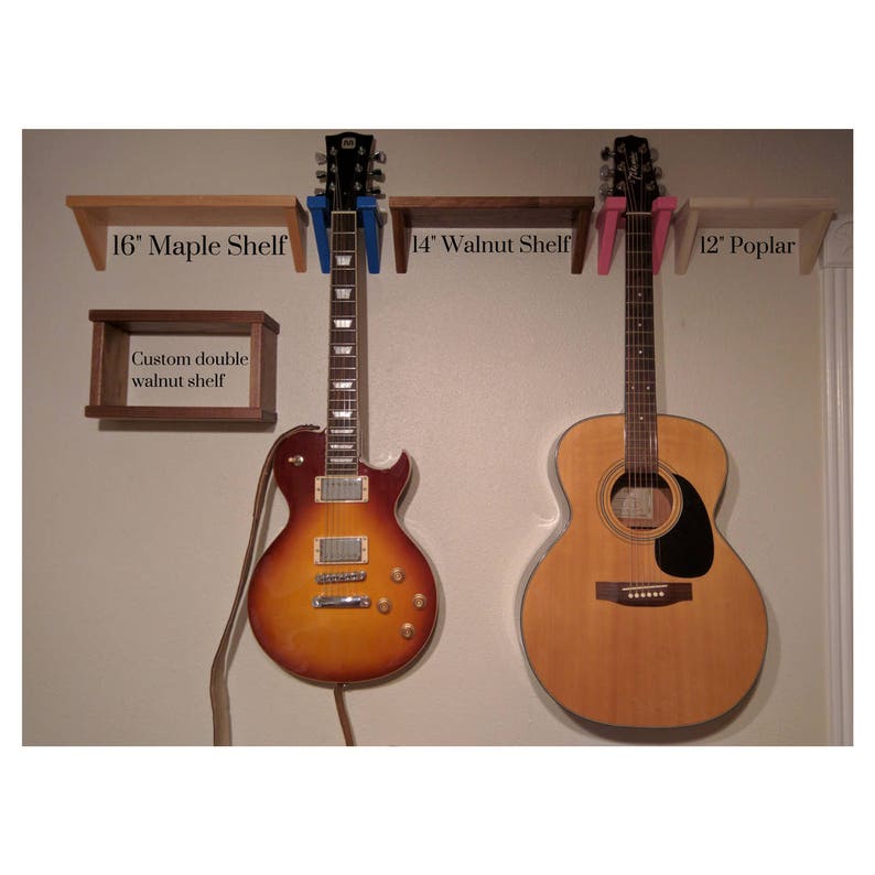 May include: Two guitars mounted on a wall with three wooden shelves. The shelves are labeled "16" Maple Shelf", "14" Walnut Shelf", and "12" Poplar". A smaller walnut shelf is labeled "Custom double walnut shelf".