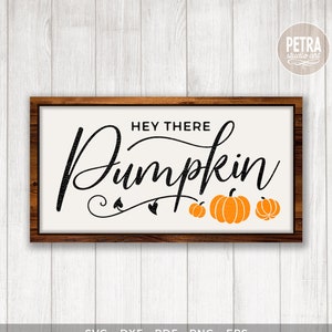 May include: A digital download of a sign with the text "Hey There Pumpkin" in black script font with three orange pumpkins. The sign is framed in a brown wood frame.