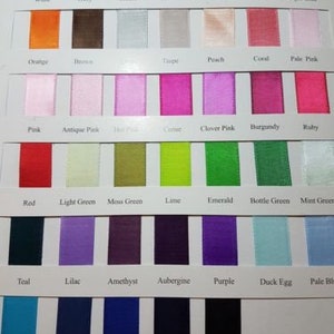 May include: A colour chart of ribbon samples with names for each colour. The colours include white, ivory, cream, lemon, yellow gold, gold, antique gold, orange, brown, taupe, peach, coral, pale pink, pink, antique pink, hot pink, carmine, clover pink, burgundy, ruby, red, light green, moss green, lime, emerald, bottle green, mint green, teal, lilac, amethyst, aubergine, purple, duck egg, pale blue, turquoise, smoke blue, royal blue, navy, and black.