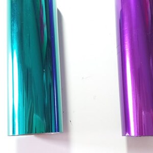 May include: Two rolls of metallic wrapping paper, one teal and one purple.