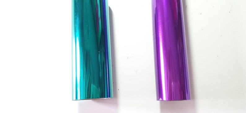 May include: Two rolls of metallic wrapping paper, one teal and one purple.