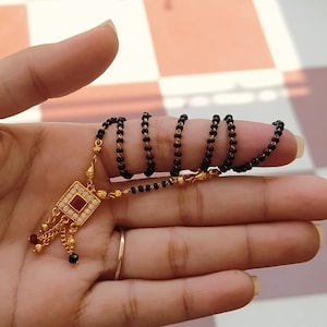 Traditional Black & Gold Beaded Mangalsutra Necklace with Square-Shaped Ruby American Diamond Gold Plated Artificial Jewellery