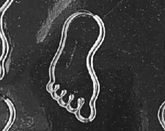 May include: A clear plastic mold for making chocolate baby footprints. The mold has eight individual cavities shaped like baby feet. The mold is labeled "Life of the Party 8986 FDA Approved".