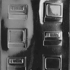 May include: A clear plastic mold with six rectangular cavities for making chocolate replicas of vintage televisions and radios. The mold has a textured surface and is designed for creating edible treats.