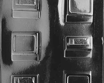 May include: A clear plastic mold with six rectangular cavities for making chocolate replicas of vintage televisions and radios. The mold has a textured surface and is designed for creating edible treats.