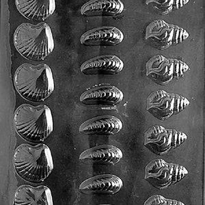 May include: A black plastic mould with 18 cavities for making chocolate seashells. The mould features two different designs: a clam shell and a spiral seashell.
