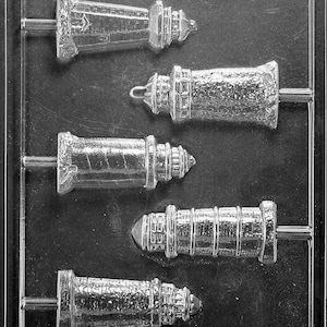 May include: A plastic mold for making chocolate lighthouse pops. The mold has five different sized lighthouse designs. The mold is labeled "Life of the Party" and has a copyright symbol.