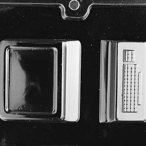 May include: A black plastic mould for making chocolate computer shapes. The mould has two sections, one for a computer monitor and one for a keyboard.