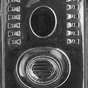 May include: A clear plastic mould with a rectangular form. It features six bow tie shapes on each side, an oval shape in the centre, and a large oval shape at the bottom. The text "LIFE OF THE PARTY 08886 FDA APP D52" is at the bottom.