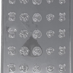 May include: A clear plastic mold with 20 cavities, each shaped like a tiny animal face. The mold includes faces of a cow, elephant, lion, monkey, and pig. The text "LIFE OF THE PARTY A 183" is visible. Cavity dimensions are 3/4" - 1-1/8" x 3/4" - 1" x 1/8" deep.