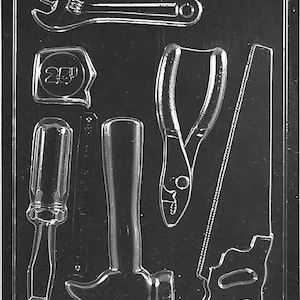 Może przedstawiać: Przezroczysta plastikowa forma z kształtami narzędzi: klucz, miarka, szczypce, piła, śrubokręt i młotek. Miarka wskazuje "25". Forma przeznaczona do tworzenia przedmiotów w kształcie narzędzi.