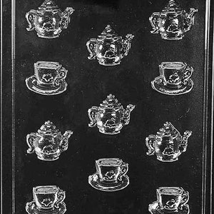 May include: A black plastic mold for making chocolate teacups and teapots. The mold has nine cavities, six for teacups and three for teapots.