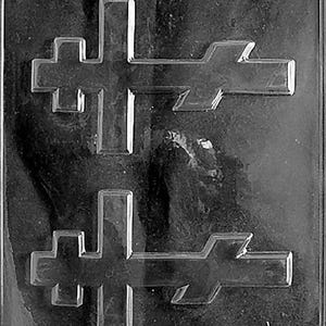 May include: Clear plastic mold with two cross-shaped cavities and two cavities resembling a stylized arrow or emblem. The mold is designed for creating decorative items, possibly chocolates or candies. The overall design is symmetrical.