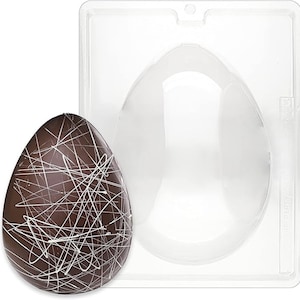 May include: A clear plastic mold for making chocolate Easter eggs. The mold is shaped like an egg and has a smooth, glossy finish. A chocolate egg with white lines is shown next to the mold.