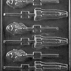 May include: A clear plastic candy mold with six cavities. Three cavities are shaped like a dinosaur head on a stick, and three are shaped like a screwdriver. The mold is designed for making chocolates or candies.